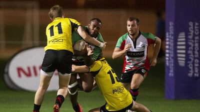 Abu Dhabi Harlequins, white, were missing Iziq Foa’i but were still able to turn away Xodus Wasps Dubai, yellow, during their Nissan Rugby League Cup match at Zayed Sports City in Abu Dhabi on April 24, 2015. Christopher Pike / The National