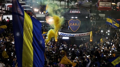 A bus transporting Boca Juniors players is received by fans near the La Bombonera stadium in Buenos Aires. EPA