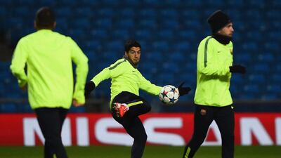 Luis Suarez of Barcelona goes to kick the ball during his team’s training session on Monday ahead of their Tuesday Champions League match against Manchester City. Laurence Griffiths / Getty Images