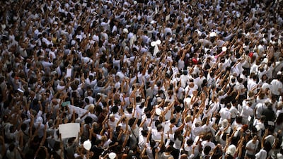 People raise their hands during a protest in favor of talks and dialogue in Sant Jaume square, Barcelona, on October 7, 2017. Emilio Morenatti / AP