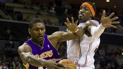 The Lakers' Ron Artest, left, duels with Gerald Wallace.