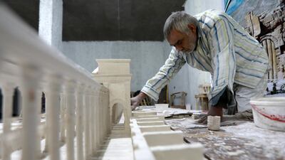 Displaced from Palmyra by Syria's 10-year conflict, Ali Saleh builds his model of the ancient city from memory, at al-Bab, northern Syria. He accompanied restoration and excavation teams for 25 years in Palmyra. AFP