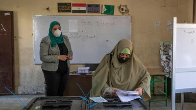 A woman casts her ballot on the first day of the Senate elections in Cairo on August 11. AP