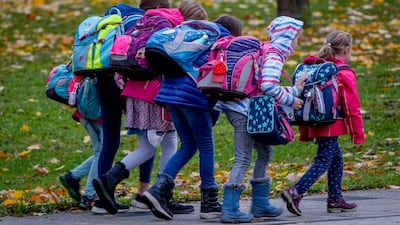 Pupils walk to school in Frankfurt. Children under 12 cannot be vaccinated against Covid-19 yet have a high rate of infections. AP Photo