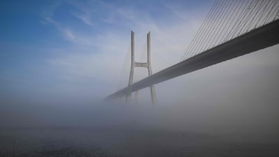 Fog obscures Vasco da Gama Bridge, in Lisbon, Portugal. AFP