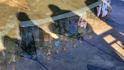 Supporters of Afghanistan's leading presidential candidate, Abdullah Abdullah, are reflected in a fountain as they attend a mass protest demonstration in Kabul, Afghanistan. AP Photo