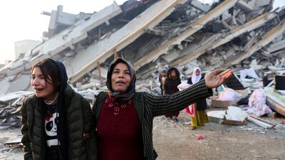 Women grieve in Hatay, Turkey. Reuters