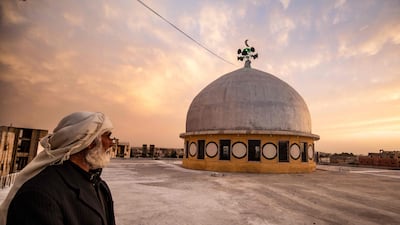 A man stares at the dome of a mosque, in Syria's northern city of Raqa. AFP