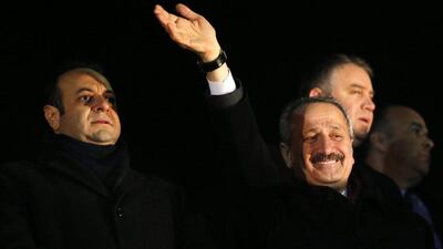 Turkey’s European Affairs Minister Egemen Bagis, left, and Economy Minister Zafer Caglayan greet their supporters at Esenboga Airport in Ankara on December 24, 2013. Caglayan was one of three Turkish ministers who resigned Wednesday after their sons were arrested in a corruption investigation that has pitted the government against the judiciary and rattled foreign investors. Photo: Umit Bektas / Reuters