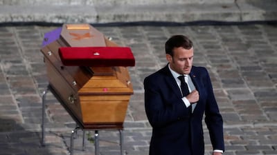 French President Emmanuel Macron leaves after paying his respects by the coffin of slain teacher Samuel Paty in the courtyard of the Sorbonne university during a national memorial event, in Paris, France October 21, 2020. REUTERS