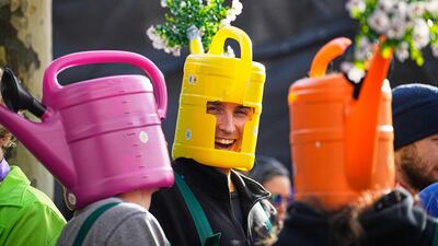 Revellers wearing customised watering cans on their heads gather in the Heumarkt in Cologne, Germany, to open carnival season. AP