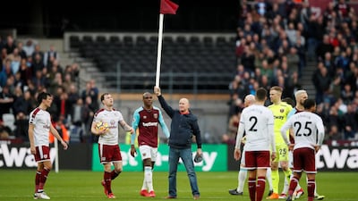 A fan holds up a corner flag after invading the pitch at West Ham vs Burnley at the London Satdium. David Klein / Reuters