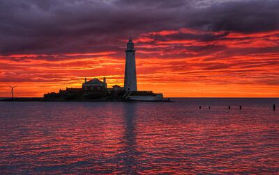 A cloudless dawn at St Mary's Lighthouse in Whitley Bay, north East England. The country is preparing for record-breaking temperatures. PA