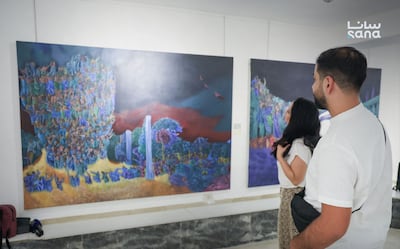 Visitors view works at the opening of the Fateh Moudarres Gallery and the Eleven Years exhibition in Damascus on September 20. Sana