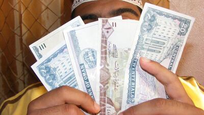 A jameeya group member, screening his face, is seen here in July 2009, supporting a call for the community financing scheme to be accepted and regulated by the Central Bank of Oman. The following year, the Omani government began asking jameeya groups to register with the ministry of social development so that they could be better regulated. Ali Saleh