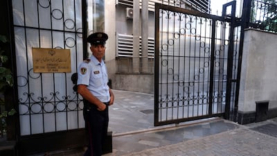 A policeman stands guard outside the Iranian Embassy in Tirana, Albania, on Wednesday. AP