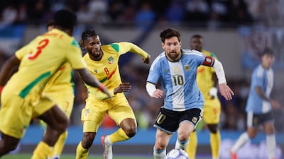 Lionel Messi vies for the ball with Imourane Hassan of Benin. EPA