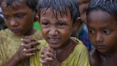 Internally displaced Rohingya boys shiver in rain in a makeshift camp for Rohingya Muslims in Sittwe, northwestern Rakhine State, Myanmar, ahead of the arrival of Cyclone Mahasen.