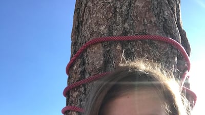 REFILE - CORRECTING TYPO Selah Schneiter, 10, of Colorado, smiles next to a tree after successfully scaling to the top of "The Nose" on El Capitan, in Yosemite Park, California, U.S., June 12, 2019 in this photo obtained from social media. Schneiter Family via REUTERS ATTENTION EDITORS - THIS IMAGE HAS BEEN SUPPLIED BY A THIRD PARTY. MANDATORY CREDIT. NO RESALES. NO ARCHIVES