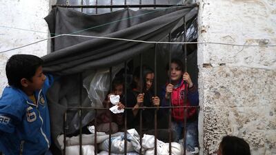 Displaced Syrian children play in a former jail turned into a makeshift shelter in the northwestern city of Idlib. AFP