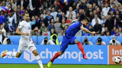 France forward Olivier Giroud shoots to score the opening goal. Tobias Schwarz / AFP