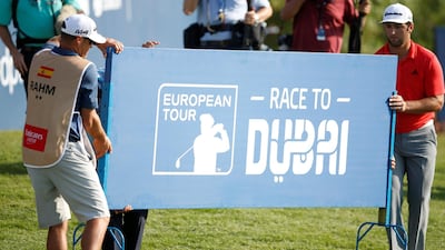 Jon Rahm (R) of Spain with his caddie carry a banner during the final round of DP World Tour Championship European Tour Golf tournament 2018 at Jumeirah Golf Estates in Dubai, United Arab Emirates. EPA