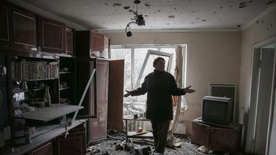 A resident in Svitlodarsk, eastern Ukraine, reacts in her home after shelling in recent days. Gleb Garanich / Reuters