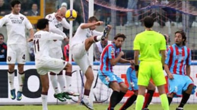 The Catania forward Gianvito Plasmati, far right, is seen with his shorts half down as teammate Guiseppe Mascara scores a free-kick past the distracted Torino keeper Matteo Sereni.