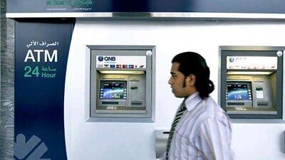 Qatar National Bank reported a 32 per cent increase in profit to 7.5 billion rials, but its shares fell by 5.2 per cent. Ryan Carter / The National