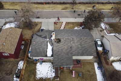 Drone aerial view shows a home with a hole in the roof from falling debris from the Boeing 777's engine in Broomfield, Colorado. AFP
