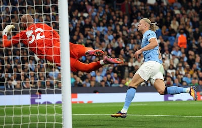Erling Haaland, right, heads in Manchester City's first goal past Napoli goalkeeper Vanja Milinkovic-Savic. EPA