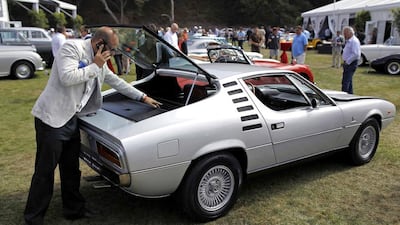 A man looks into the hatch of a 1974 Alfa Romeo Montreal. Michael Fiala / Reuters