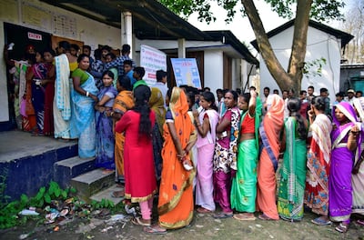 People wait in queues to cast their votes outside a polling station during the second phase of general election in Assam, India. Reuters