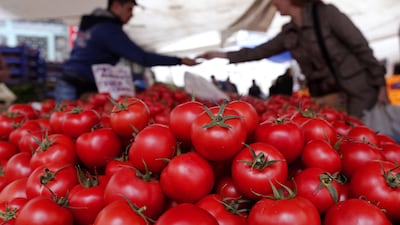 A Turkish woman buys tomatoes in a local market in Istanbul, Turkey. Inflation has surged as food and transport prices rise. Sedat Suna / EPA