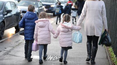 Parents walk their children to school in Hornchurch, Essex. PA