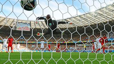 Marouane Fellaini of Belgium, right, scores his team's first goal on a header past Rais M'Bolhi of Algeria to make it 1-1 during their 2014 World Cup Group H match on Tuesday. Quinn Rooney / Getty Images