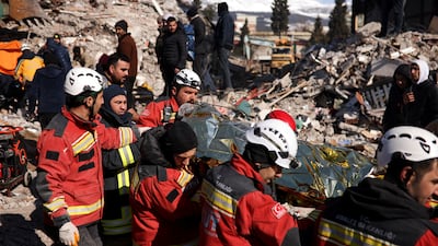 Rescuers carry a survivor at the site of a collapsed building in Kahramanmaras, Turkey. Reuters