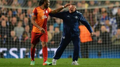 Didier Drogba of Galatasaray and Stamford Bridge groundsman Jason Griffin reacquaint themselves before Tuesday's match. Mike Hewitt / Getty Images / March 18, 2014