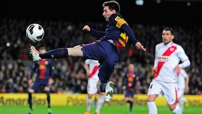 Barcelona's Lionel Messi leaps to meet the ball ahead of Rayo Vallecano's Mikel Labaka.