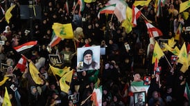 Hezbollah supporters wave flags and hold a portrait of slain leader Hassan Nasrallah during an anti-US and anti-Israel protest in Beirut last week. AFP
