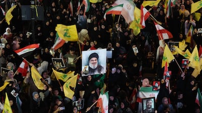 Hezbollah supporters wave flags and hold a portrait of slain leader Hassan Nasrallah during an anti-US and anti-Israel protest in Beirut last week. AFP