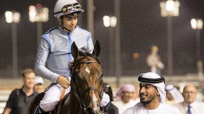Jockey Mickael Barzalona and trainer Salem bin Ghadayer, pictured with Heavy Metal after their win at Meydan. Erika Rasmussen for The National