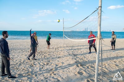 People with disabilities play beach volleyball during an organised outdoor trip. Courtesy Wake Up Adventures