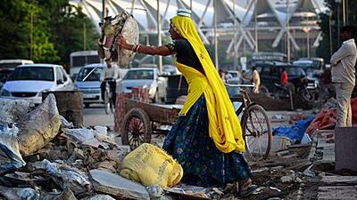 An Indian worker at an unfinished construction site next to the lawn bowling venue outside Jawaharlal Nehru Stadium, the main venue for the Commonwealth Games. Kevin Frayer/ AP Photo