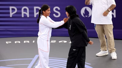 Refugee team member Manizha Talash greets India Sardjoe of Netherlands during their breaking pre-qualifier. Getty Images