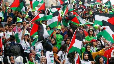 Palestine's supperters wave their national flags ahead of the World Cup 2022 Asian qualifying match between Palestine and Saudi Arabia in the town of al-Ram in the Israeli occupied West Bank. The game would mark a change in policy for Saudi Arabia, which has previously played matches against Palestine in third countries. Arab clubs and national teams have historically refused to play in the West Bank, where the Palestinian national team plays, as it required them to apply for Israeli entry permits. AFP