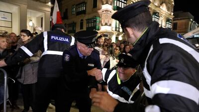 A policeman was injured as demonstrators protest outside Malta's House of Parliament. EPA