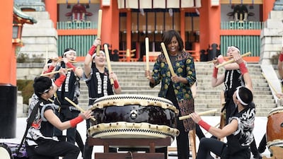 US first lady Michelle Obama plays taiko drums with members of the Akutagawa High School Taiko Club during her visit at Fushimi Inari Taisha Shrine in Kyoto on March 20. EPA
