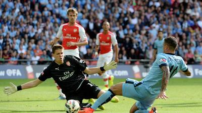 Goalkeeper Wojciech Szczesny of Arsenal competes against Aleksandar Kolarov of Manchester City during the FA Community Shield match between Manchester City and Arsenal at Wembley Stadium on August 10, 2014 in London, England. Ross Kinnaird/Getty Images