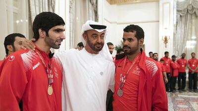 Sheikh Mohammed bin Zayed, Crown Prince of Abu Dhabi and Deputy Supreme Commander of the UAE Armed Forces (R), stands for a photograph with members of the UAE Special Olympics team, during a Sea Palace barza. Mohamed Al Hammadi / Crown Prince Court - Abu Dhabi